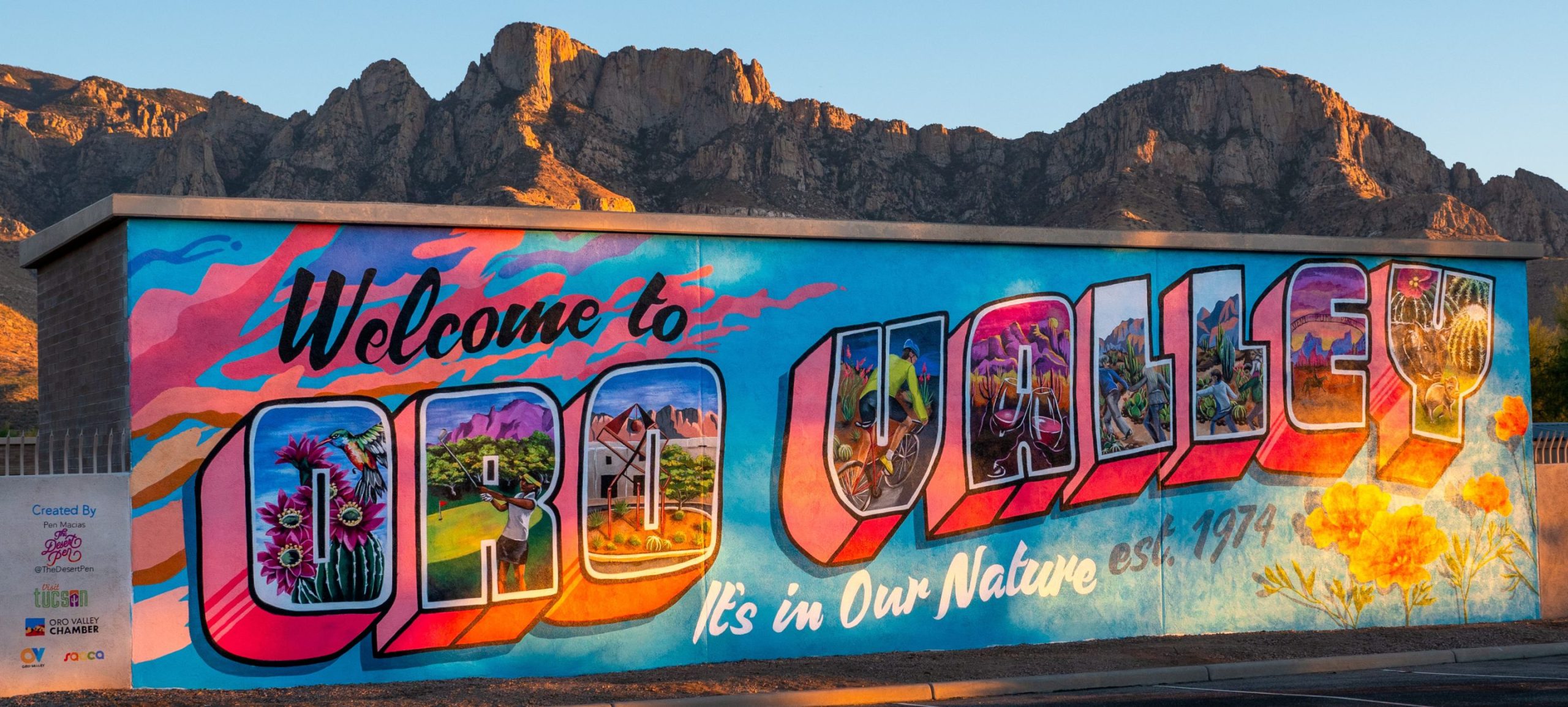 The Welcome to Oro Valley mural with the mountains behind it