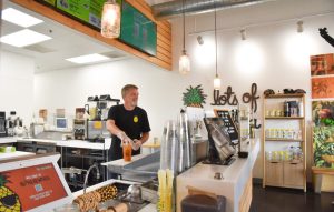 A worker behind the counter at Wow Wow Hawaiian Lemonade