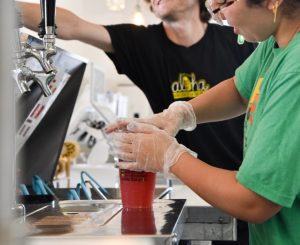 Staff in gloves preparing drinks
